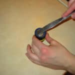 using a knife to pry apart the o-ring from the volcano vaporizer herb filling chamber
