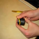 hands rolling outside yellow o-ring off of volcano vaporizer filling chamber