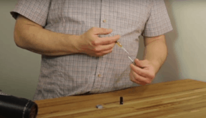 showing how to refill a vape cartridge with syringe